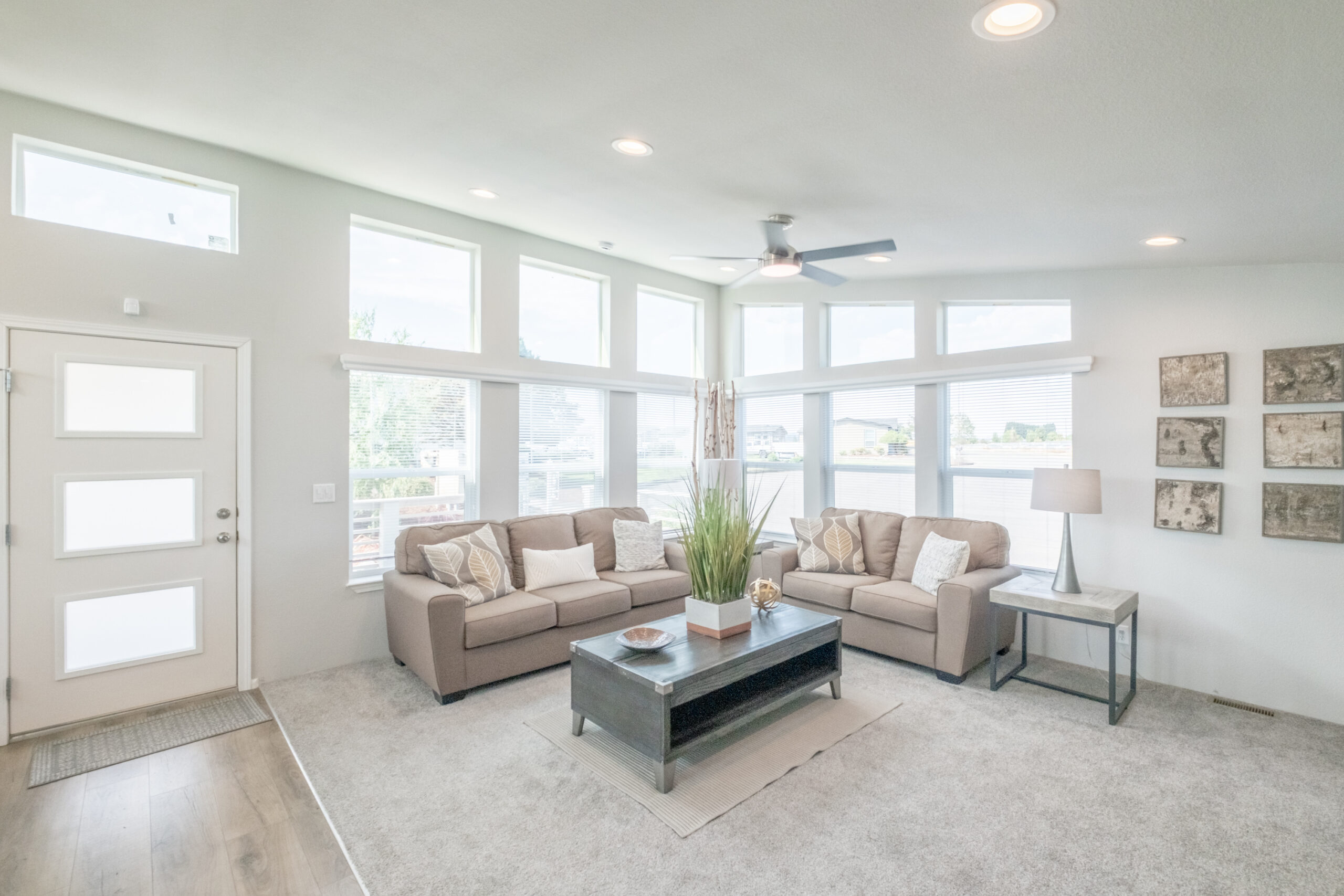 spacious living room with large windows in manufactured home